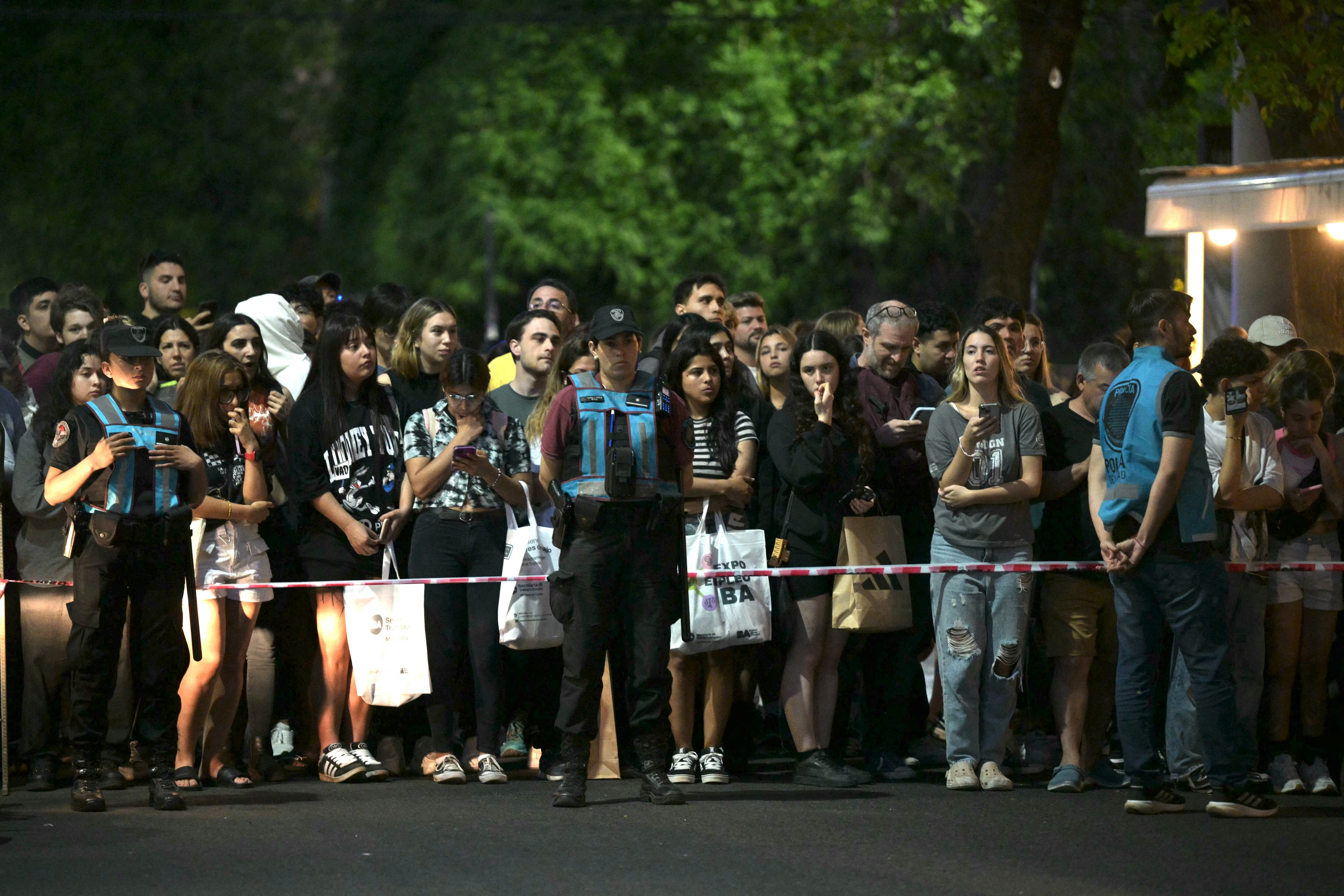 Fans of British singer Liam Payne cry next to the hotel where he died in Buenos Aires on October 16, 2024. British singer Liam Payne, former member of the group One Direction, died Wednesday aged 31 after falling from the third floor of a hotel in Argentina, police in Buenos Aires said. (Photo by Luis ROBAYO / AFP) (Photo by LUIS ROBAYO/AFP via Getty Images)