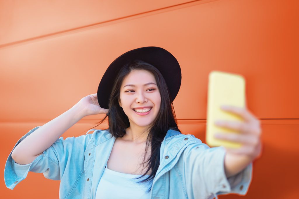 Happy Asian Girl Taking Selfie With Mobile Smart Phone Outdoor Trendy Influencer Having Fun With New Trends Social Networks Apps Millennial Generation Lifestyle People Addicted Technology
