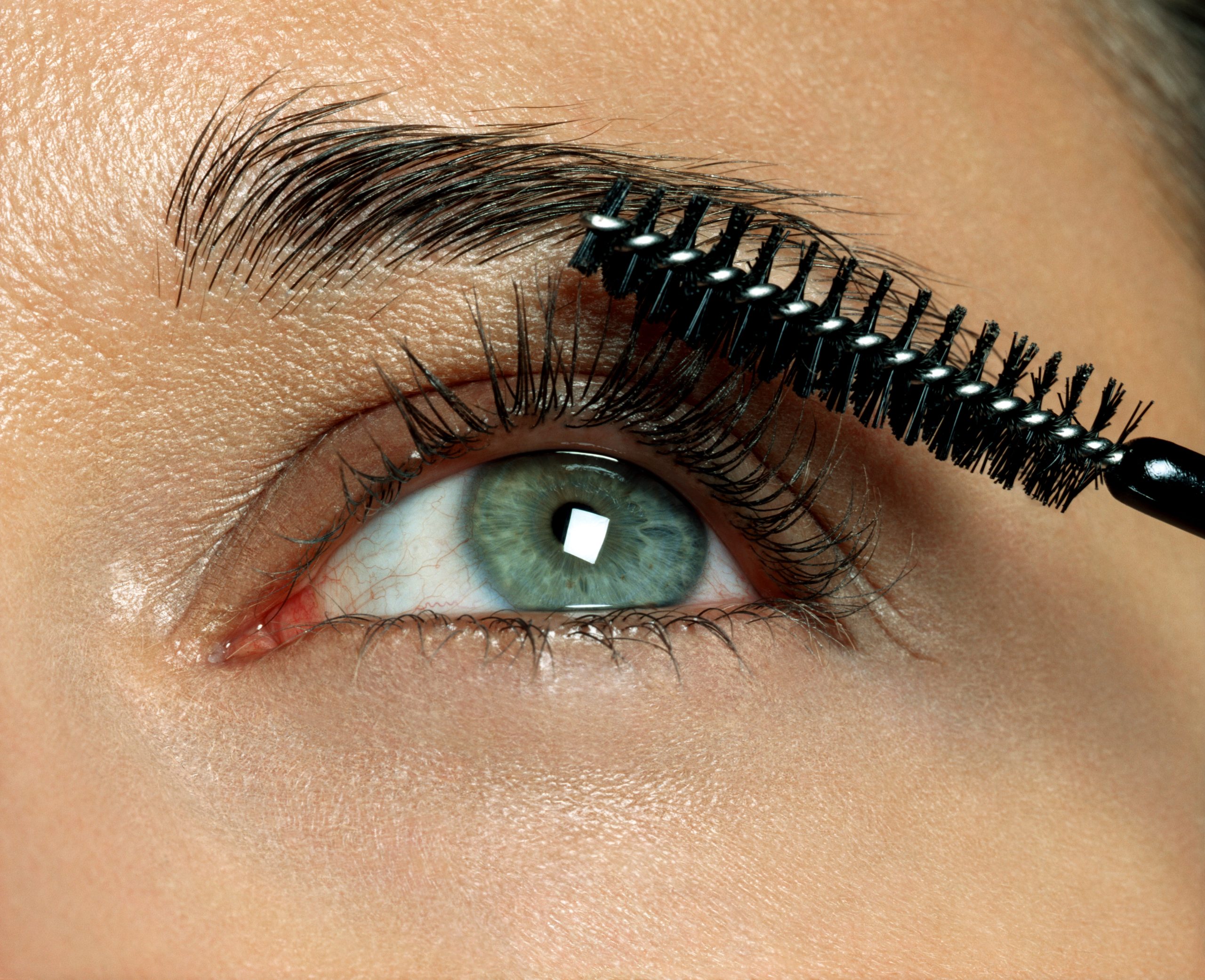 Woman Applying Eyelash Makeup, Close Up